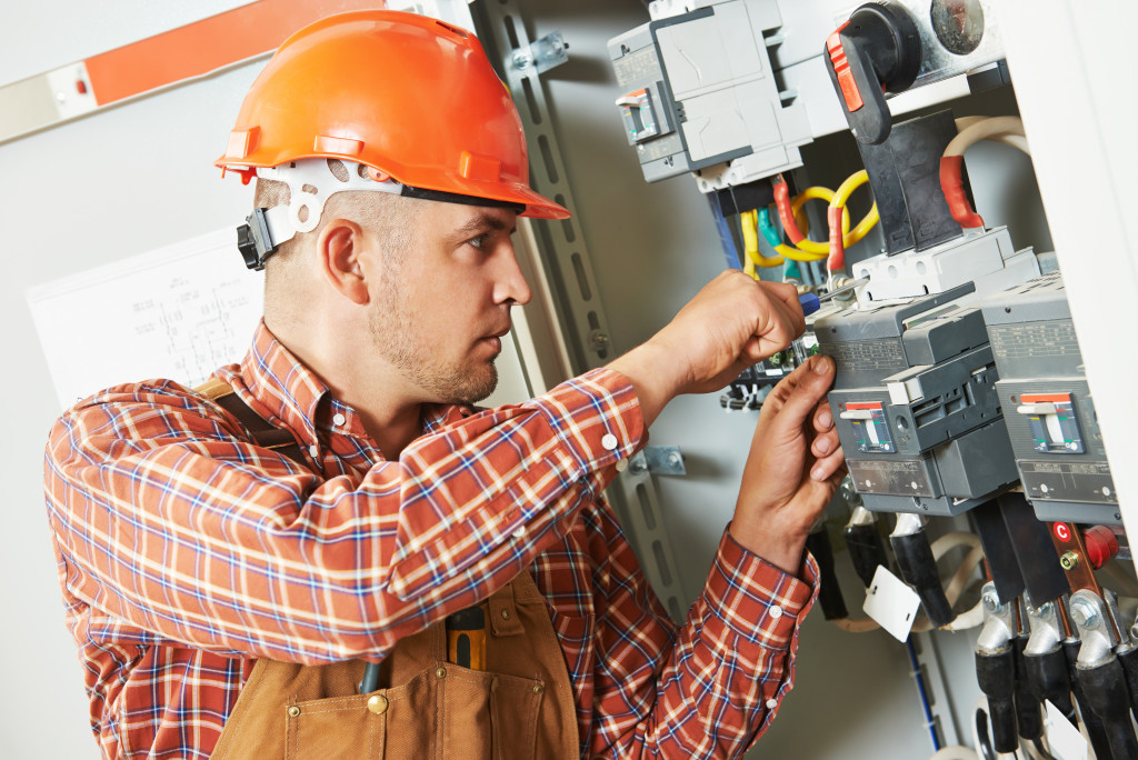 electrician fixing a fuse box
