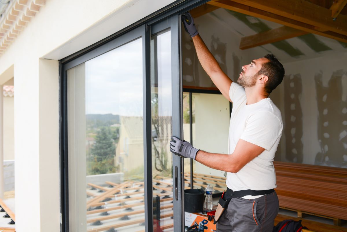man installing sliding glass door