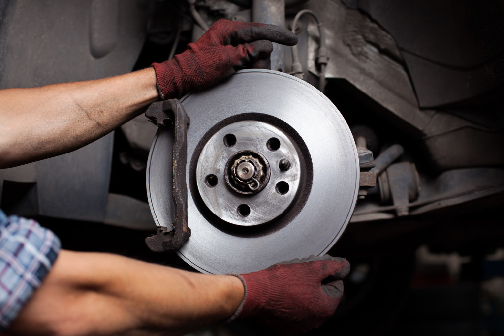 mechanic replacing brakes