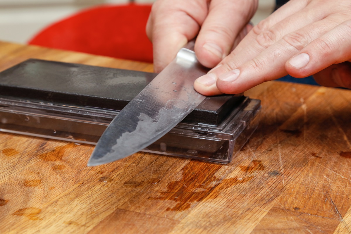 A person sharpening a knife